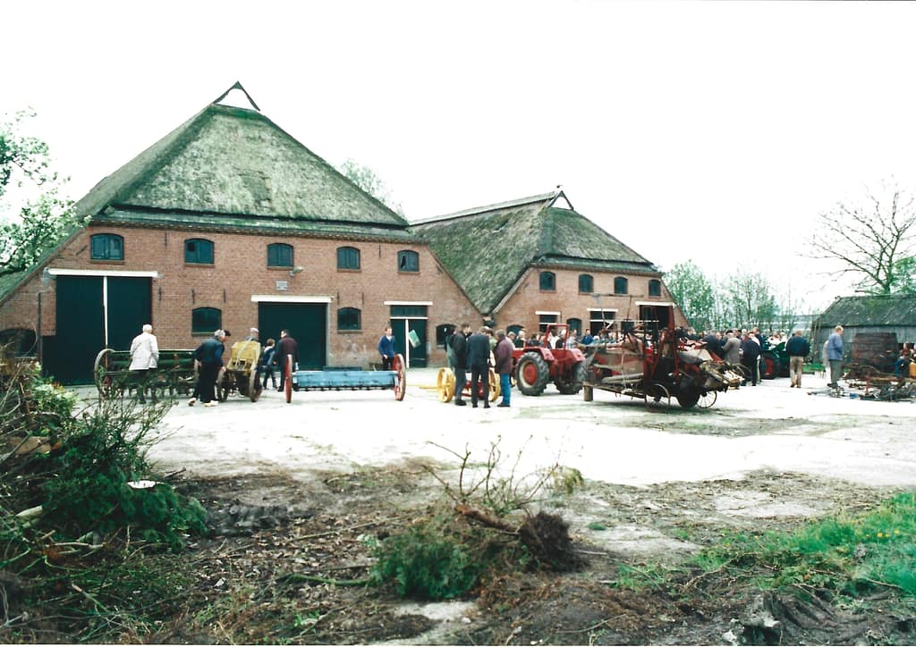Foto van de boeldag die begin 21e eeuw op De Tackenborg werd georganiseerd. Op het achtererf staan diverse landbouwwerktuigen opgesteld en is een grote groep geïnteresseerden te zien.